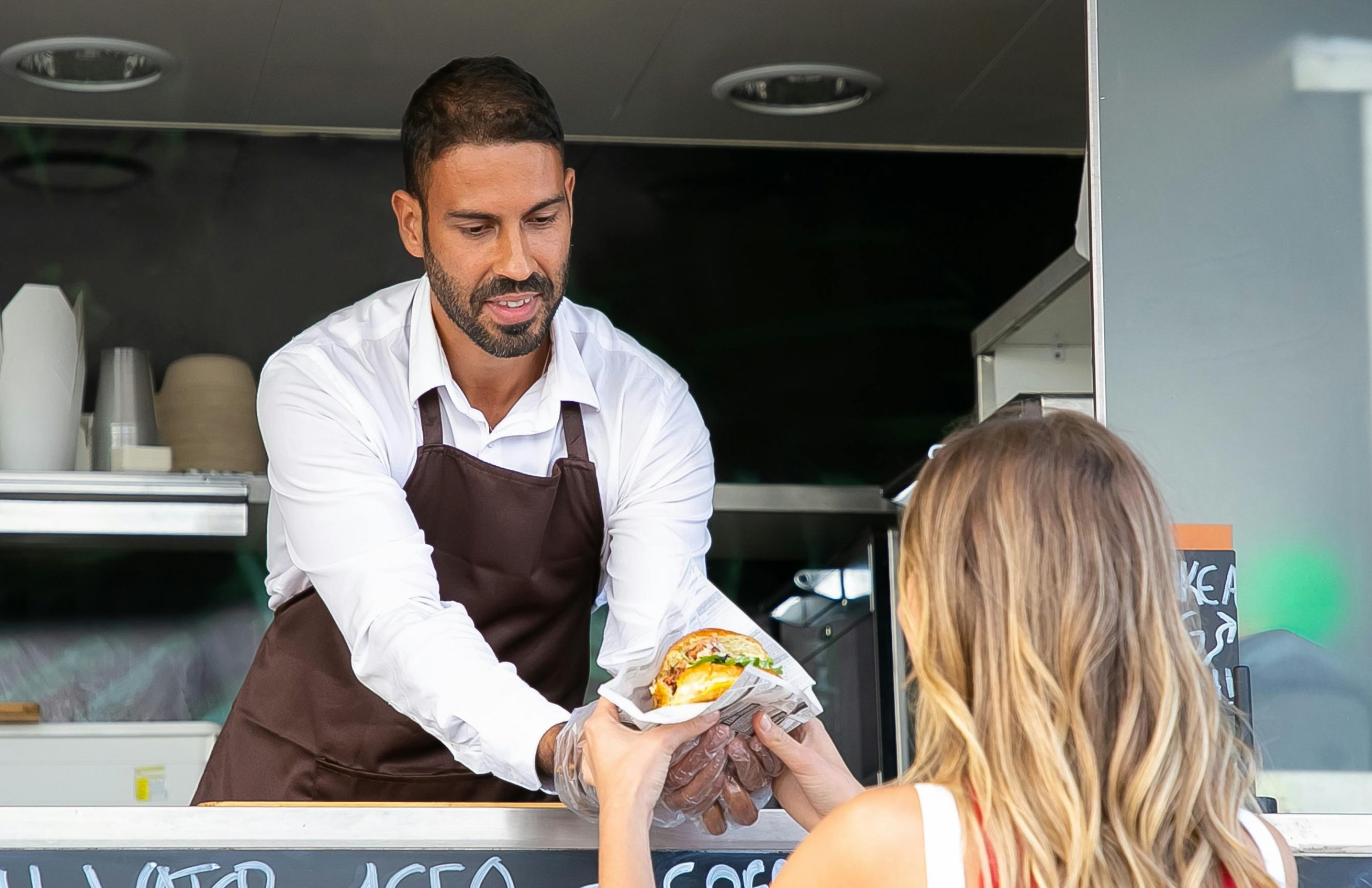 Customer at a food market checking their phone